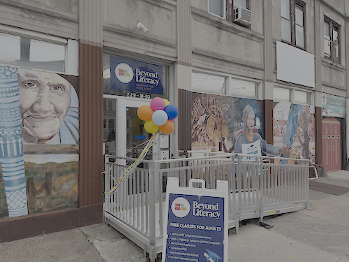 The front door of Beyond Literacy with signage and balloons.